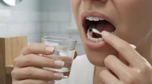 Close-up of a person washing a tooth cavity with warm water before applying temporary dental filling.