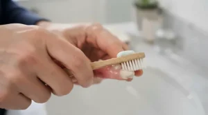 Demonstrating the correct brushing technique along the gumline with a dentist-recommended specialist toothpaste.