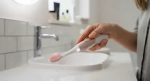 Step-by-step guide illustrating how to position an affordable electric gum massager along the gumline for daily dental care.