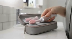 Compact electric gum massager packed inside a sleek travel case alongside toiletries for weekend breaks.